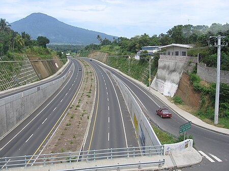 The road to San Salvador, leaving from Apopa. Vertical road leads to Quezaltepeque. The volcano of San Salvador is seen in the distance. Rd to SS.jpg