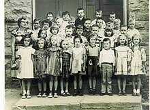First grade class standing in front of Booneville Elementary School, former Booneville Co-Educational Institute, 1954 Parish 1st Grade Class 1954.jpg