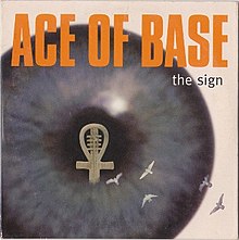 A close-up shot of an eyeball with an ankh inside. The text above reads Ace of Base – The Sign