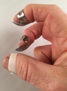 Finger picks on thumb, index and middle finger