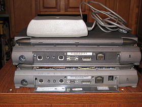 The door on the 550c is removed, and some trim on the 520c is removed, showing the external interfaces.
Ports from left to right are: Power in, printer/modem, sound in, sound out, ADB, AAUI, monitor out, SCSI (HDI-30 connector), modem port, and Kensington key-lock. Note the 550c hinge cover is darker. Note the labels on the door needed to identify the internal modem (FCC info on the "PowerPort" label, Canadian on other two). The 100-240 V power supply is on top. PowerBook 500 rear detail.jpg