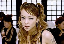 Still from the music video showing Amuro on a white painted Japanese style stage set with additional backup dancers. ShinemoreMusicVideo.jpg