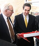 John M. Longo (right) presenting [[Warren Buffett]] with a gift on behalf of [[Rutgers University|Rutgers Business School]]