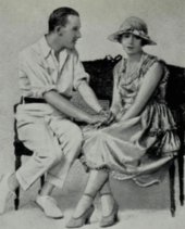 young white man and woman holding hands