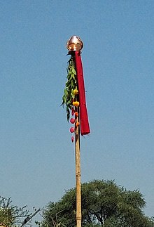 Raising gudhi is main ritual of Gudhi Paadvaa Gudipadwagudi.jpg