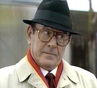 Frank in the early 1990s. The character was often seen wearing a trilby, raincoat and large tinted glasses. Francis butcher.jpg