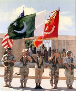 A Piffer infantryman (centre) in Somalia, with the green flag of Pakistan.