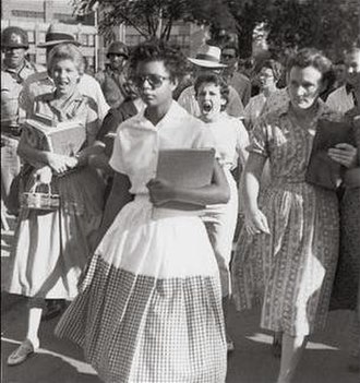 Elizabeth Eckford attempts to enter Little Rock Central High on 4 September 1957. The girl shouting is Hazel Bryan.