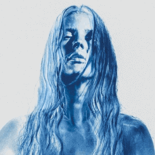 Image of a female with wet hair and negative blue hue effect.