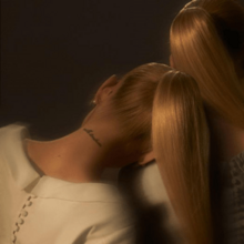 Standard cover art of "Eternal Sunshine": a photo showing the back of Grande's head as she sports a blonde ponytail and white dress while resting on the shoulder of a similarly dressed woman