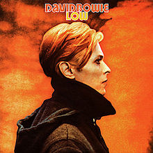 A man with orange hair in profile looking to the right against an orange backdrop, with the words "David Bowie" and "Low" above him