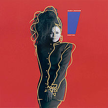 A young woman poses in front of a red background. She is wearing a long black button-up jacket with matching gloves, pants and headdress. The headdress flips her black hair forward over the right side of her face. To her left is a blue trapezoid that tapers downward, and reads "Janet Jackson" above it and "Control" below.