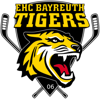 Logo représentant une tête de tigre devant deux crosses croisées et surmontée du texte "EHC BAYREUTH TIGERS"