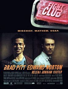 "FIGHT CLUB" is embossed on a pink bar of soap in the upper right. Below are head-and-shoulders portraits of Brad Pitt facing the viewer with a broad smile and wearing a red leather jacket over a decorative blue t-shirt, and Edward Norton in a white button-up shirt with a tie and the top button loosened. Norton's body faces right and his head faces the viewer with little expression. Below the portraits are the two actors' names, followed by "HELENA BONHAM CARTER" in smaller print. Above the portraits is "MISCHIEF. MAYHEM. SOAP."