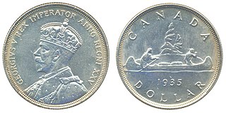 Канадский доллар Георга V. 1935, серебро. Дизайн «лодочник» (voyageur) на реверсе (автор Э. Хан) использовался в 1935—1986 гг.