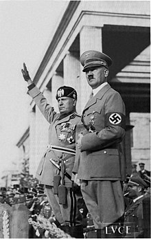 Mussolini and Hitler saluting troops